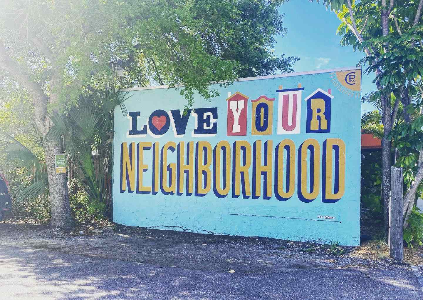 painted sign that says love your neighborhood